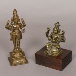 A bronze figure of Vishnu The four-armed deity modelled seated,