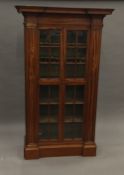 An early 19th century satinwood display cabinet Of architectural form,