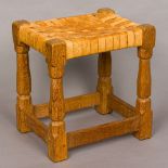 ROBERT MOUSEMAN THOMPSON of KILBURN An adzed oak stool with a tan lattice work seat,