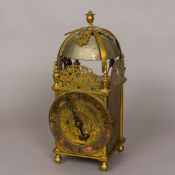 A brass lantern clock The case of typical form with finial mounted top above a bell and circular