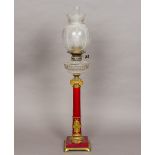 A Victorian ormolu mounted porcelain oil lamp Of red glazed columnar form,