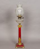 A Victorian ormolu mounted porcelain oil lamp Of red glazed columnar form,