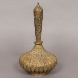 An ornate 19th century Indo-Persian gilt copper bottle vase Together with a brass model of a stupa