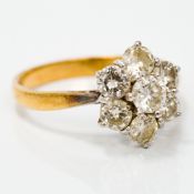 An 18 ct gold and diamond ring Flowerhead set. 1.1 cm high.