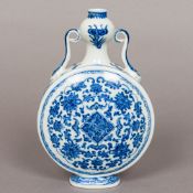 A Chinese blue and white porcelain moon flask Of typical form, with twin scrolling handles,