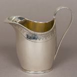 A George III silver cream jug, hallmarked for Sheffield 1799,
