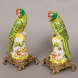 A pair of porcelain parrots Each modelled standing on a tree stump,