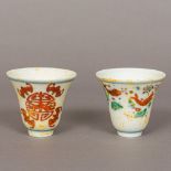 A pair of Chinese porcelain drinking vessels Each of flared form, one decorated with fish,