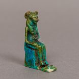 A small Egyptian faience pendant Formed as the cat goddess Bastet, modelled seated,