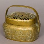 A late 19th century Chinese brass hand warmer Of typical form with pierced removable lid and loop