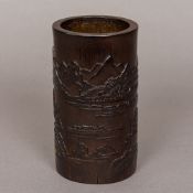 A Chinese carved bamboo brush pot Decorated in the round with boats and pagodas amongst a