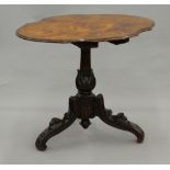 A 19th century Black Forest penwork centre table The shaped top decorated with vignettes of deer,