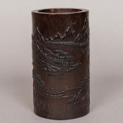 A Chinese carved stained bamboo brush pot Decorated in the round with figures,