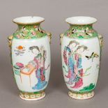 A pair of 19th century Canton famille rose porcelain vases Each with twin mask and loop handles,