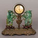 A bronze clear glass and jade set desk clock The circular dial with Arabic numerals,