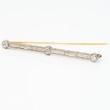 A 1930s Art Deco platinum and diamond bar brooch 6.25 cm long.