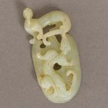 A Chinese celadon jade carving Depicting a dragon and a dog-of-fo. 7.5 cm high.