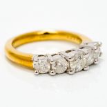 An 18 ct gold five stone diamond ring Set with five stepped claw set stones.