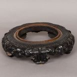 A 19th century Chinese carved hardwood stand Of circular form,