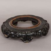 A 19th century Chinese carved hardwood stand Of circular form,