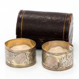 A pair of cased Victorian silver napkin rings, hallmarked London 1881,