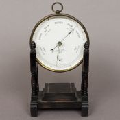 A Victorian Newton & Co lacquered brass cased aneroid barometer Of circular form,