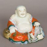 A 19th century Chinese porcelain figure of Buddha Typically modelled seated in gilt decorated open