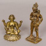 A gilded bronze figure of a four armed deity Modelled in the seated position;