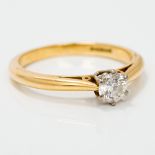 An 18 ct gold diamond solitaire ring The claw set stone approximately 0.25 carat.