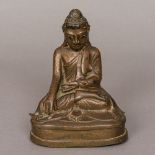 A Chinese gilt bronze figure of Buddha Typically modelled seated in the lotus position,