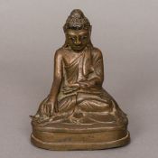 A Chinese gilt bronze figure of Buddha Typically modelled seated in the lotus position,