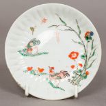 A small Japanese Kakiemon dish Decorated with chickens, butterflies and floral sprays.