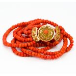 A five strand coral bead necklace Set with 18 ct gold filigree clasp. Approximately 40 cm long.