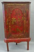 A mid-18th century red japanned hanging corner cupboard (now on later stand) The moulded cornice