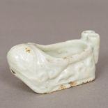 A Chinese celadon ground porcelain bird feeder Of rounded rectangular form with two suspension
