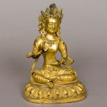 A Chinese gilt bronze figure of Buddha Typically modelled seated in the lotus position,