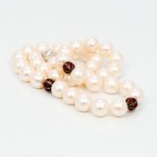 A pearl bead necklace Set with three diamond and enamel decorated roundels and with 18 ct white