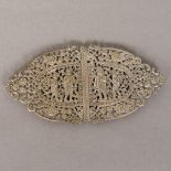 A 19th century Indian unmarked silver buckle Of two part pierced scrolling form,