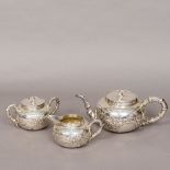 A Chinese silver three piece tea set Each piece of globular form with faux bamboo handles decorated