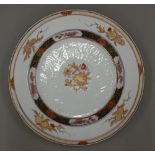 An 18th century Chinese porcelain plate Decorated with gilt heightened pomegranates.