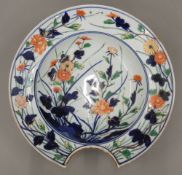 A 19th century Japanese porcelain barber's bowl Decorated in the Imari palette with gilt heightened