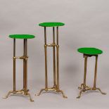 Three late 19th/early 20th century adjustable shop display stands Each of tubular brass form,