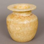 An Egyptian alabaster vase The flared rim above the short neck and squat bulbous body. 16.