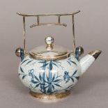 A Japanese sterling silver mounted blue and white crackle glaze teapot With angular architectural