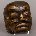 A North American Indian carved wooden mask 15.5 cm high.