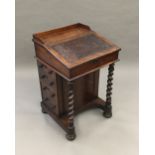 A William IV rosewood Davenport The rectangular top with solid three quarter gallery above the