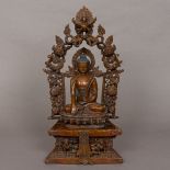 A patinated bronze figure of Buddha Modelled seated in the lotus position on a stepped plinth base