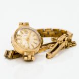 A lady's 9 ct gold cased Rolex wristwatch The circular dial set with batons. 1.2 cm wide.