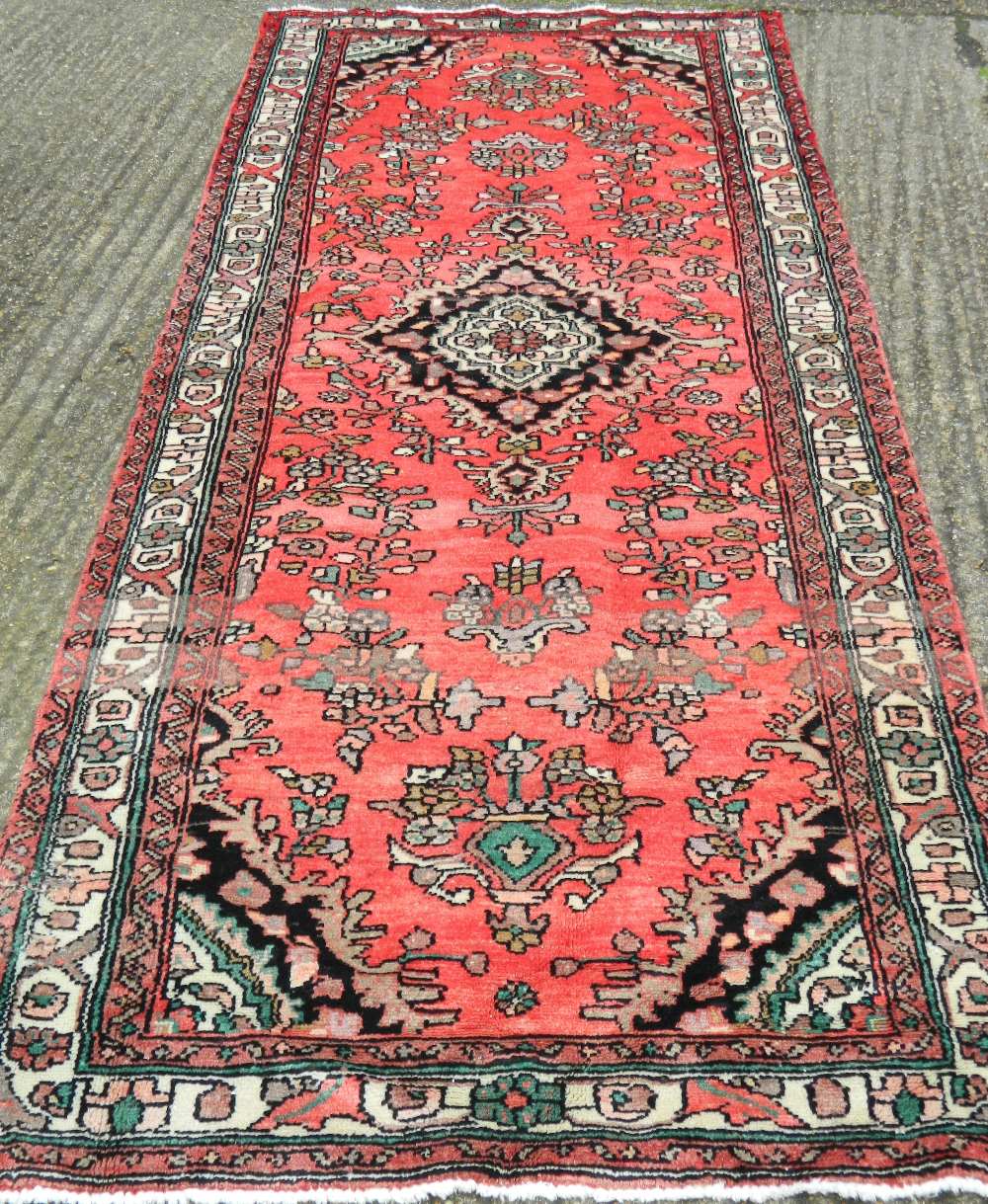 A red ground Hamadan runner 311 x 108 cm.