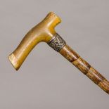 An Edwardian silver mounted rhinoceros horn cane handle The embossed silver collar marked for
